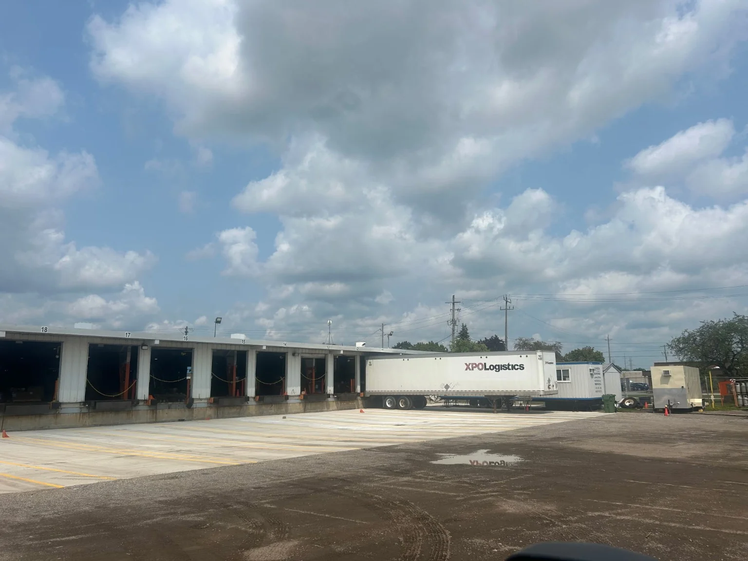 Finished concrete loading dock surface in front of industrial warehouse doors
