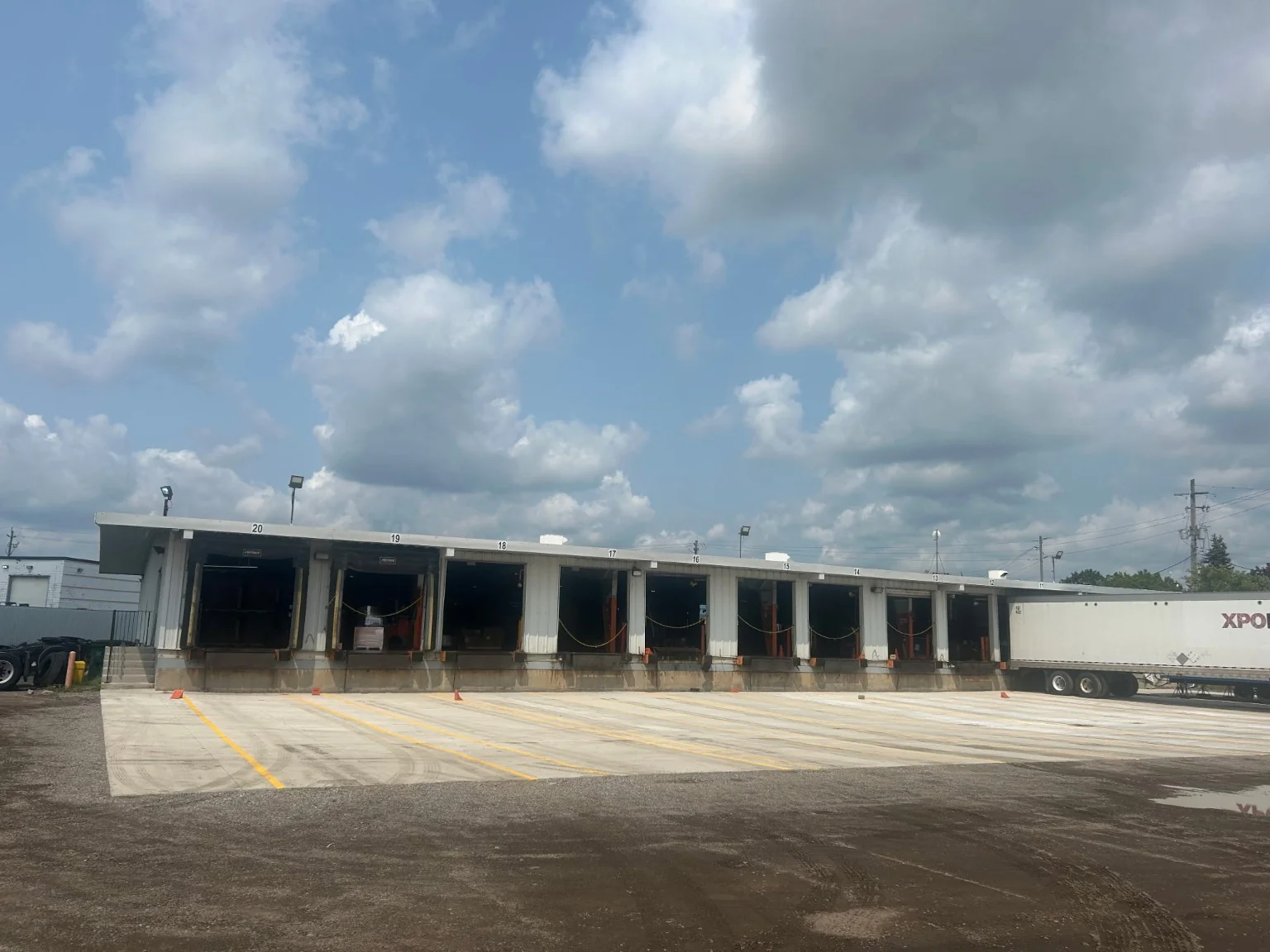 Multiple-bay commercial loading facility with newly finished concrete apron.